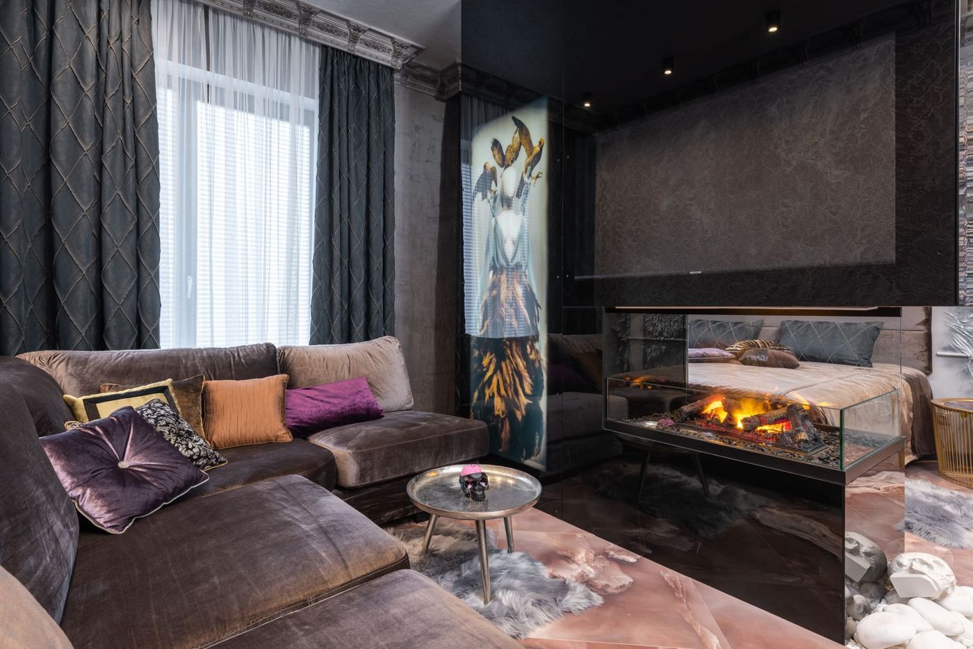 A sitting room with a contemporary glass-fronted gas fire alight alongside the seating